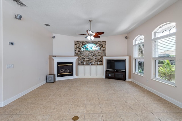 5 Florence Ct, Palm Coast, FL 32137 - unfurnished living room with a ceiling fan, light tile patterned flooring, and a glass covered fireplace