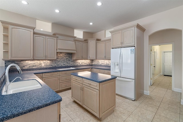 5 Florence Ct, Palm Coast, FL 32137 - kitchen with white refrigerator with ice dispenser, a sink, dark countertops, tasteful backsplash, and light tile patterned floors