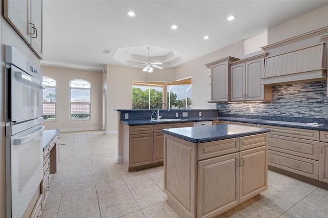 5 Florence Ct, Palm Coast, FL 32137 - kitchen with a raised ceiling, a sink, a peninsula, a textured ceiling, and tasteful backsplash