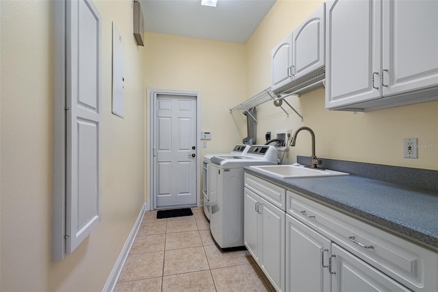 5 Florence Ct, Palm Coast, FL 32137 - washroom featuring washing machine and dryer, cabinet space, light tile patterned flooring, and baseboards