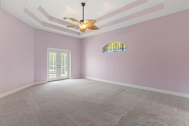5 Florence Ct, Palm Coast, FL 32137 - spare room featuring a raised ceiling, french doors, light carpet, a ceiling fan, and baseboards