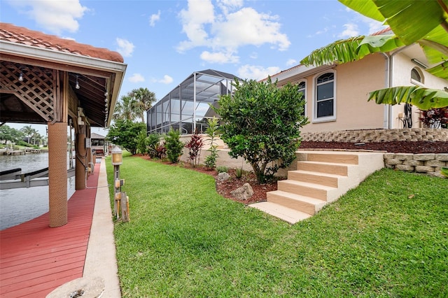 5 Florence Ct, Palm Coast, FL 32137 - view of green lawn featuring a dock and glass enclosure