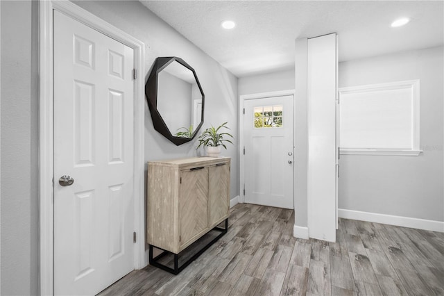 3251 Wickersham Ct, Orlando, FL 32806 - foyer entrance with light wood-type flooring, recessed lighting, and a textured ceiling