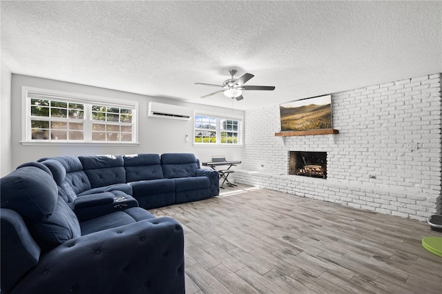 3251 Wickersham Ct, Orlando, FL 32806 - living area with a wall mounted air conditioner, ceiling fan, wood finished floors, a brick fireplace, and a textured ceiling