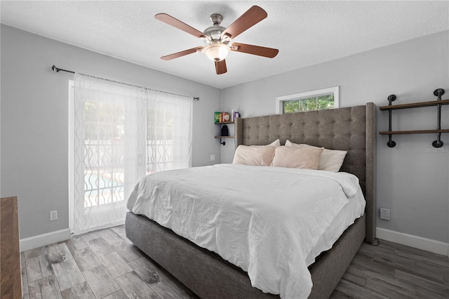 3251 Wickersham Ct, Orlando, FL 32806 - bedroom featuring access to outside, wood finished floors, a textured ceiling, and a ceiling fan