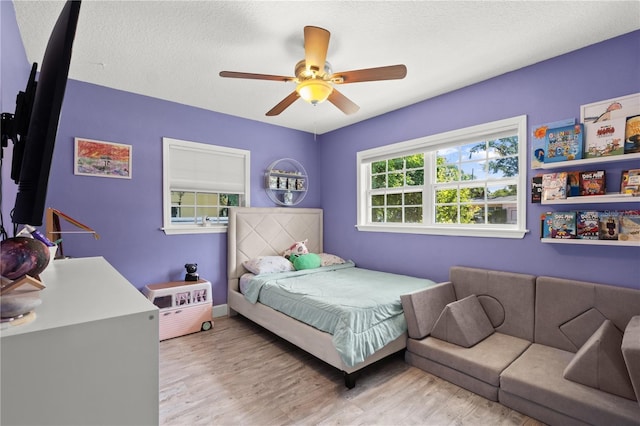 3251 Wickersham Ct, Orlando, FL 32806 - bedroom with wood finished floors, a ceiling fan, and a textured ceiling