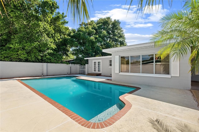 3251 Wickersham Ct, Orlando, FL 32806 - view of pool featuring a patio area, a fenced backyard, and french doors