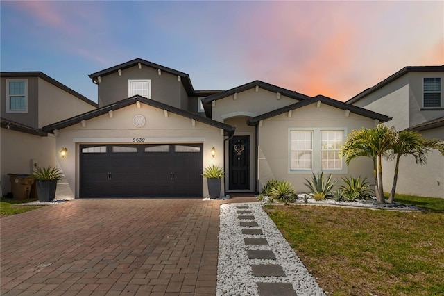 5639 Timber Meadow Way, Saint Cloud, FL 34771 - view of front of property with stucco siding, decorative driveway, an attached garage, and a front lawn