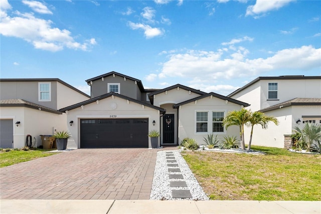 5639 Timber Meadow Way, Saint Cloud, FL 34771 - view of front of property with decorative driveway, stucco siding, a garage, and a front lawn
