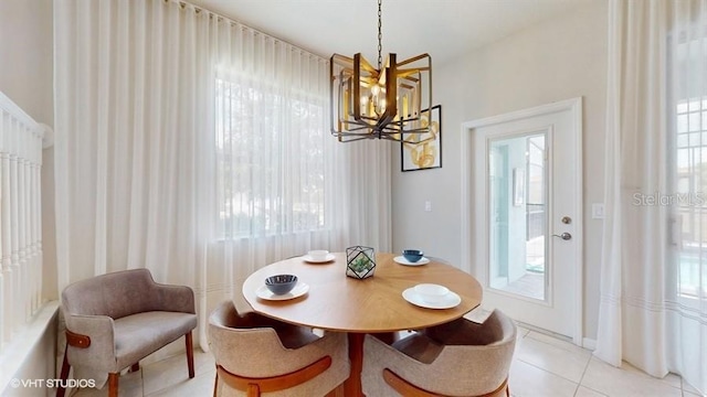 8900 Sydney Ave, Kissimmee, FL 34747 - dining room featuring a chandelier, light tile patterned flooring, and plenty of natural light