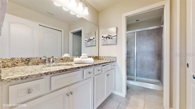 8900 Sydney Ave, Kissimmee, FL 34747 - full bathroom featuring vanity, tile patterned flooring, and a stall shower