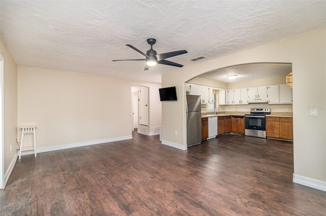 13 Scott Ln, Rockledge, FL 32955 - kitchen featuring appliances with stainless steel finishes, under cabinet range hood, a ceiling fan, dark wood-style floors, and arched walkways