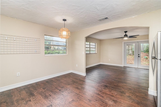 13 Scott Ln, Rockledge, FL 32955 - spare room with wood finished floors, arched walkways, ceiling fan, baseboards, and french doors