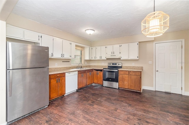 13 Scott Ln, Rockledge, FL 32955 - kitchen with appliances with stainless steel finishes, under cabinet range hood, light countertops, dark wood-style flooring, and a chandelier