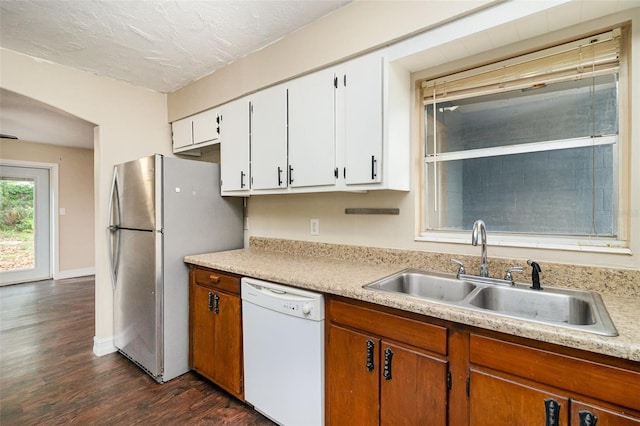 13 Scott Ln, Rockledge, FL 32955 - kitchen with dishwasher, a sink, freestanding refrigerator, dark wood-style floors, and light countertops