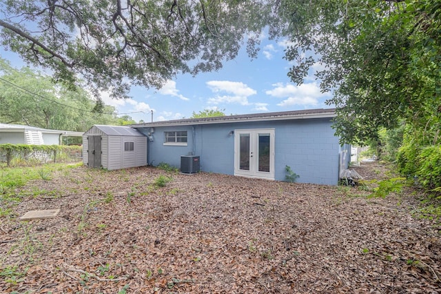 13 Scott Ln, Rockledge, FL 32955 - back of house featuring concrete block siding, french doors, and central AC