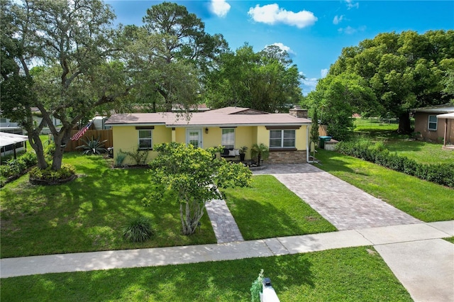 1649 W Waycross Cir, Deltona, FL 32725 - view of front of house featuring stucco siding and decorative driveway