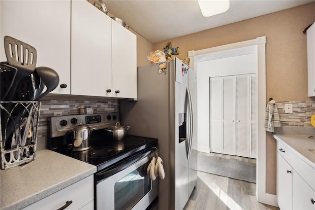 1649 W Waycross Cir, Deltona, FL 32725 - kitchen with stainless steel electric stove, backsplash, light countertops, white cabinets, and light wood-style flooring