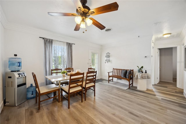 1649 W Waycross Cir, Deltona, FL 32725 - dining area featuring light wood-style flooring, ornamental molding, ceiling fan, and baseboards