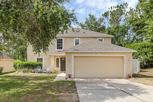 2255 Tealwood Cir, Tavares, FL 32778 - traditional home featuring stucco siding, a garage, driveway, and roof with shingles