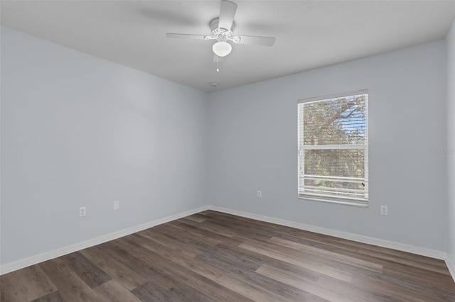 2255 Tealwood Cir, Tavares, FL 32778 - empty room with dark wood-style floors, a ceiling fan, and baseboards