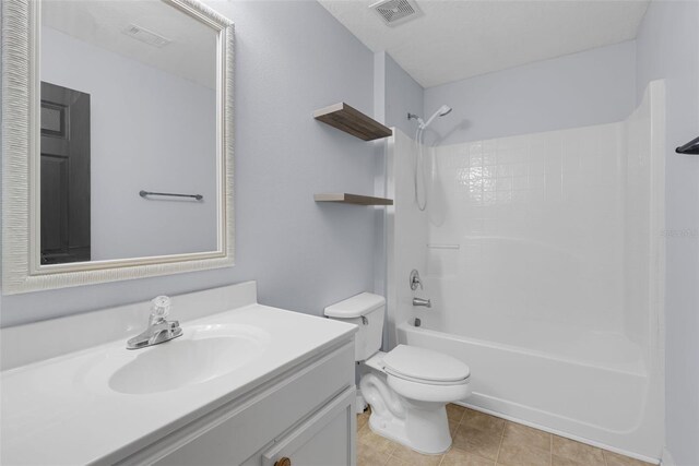 2255 Tealwood Cir, Tavares, FL 32778 - full bath featuring vanity, bathing tub / shower combination, toilet, and tile patterned floors