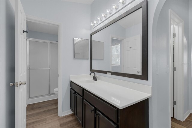 2255 Tealwood Cir, Tavares, FL 32778 - full bath with vanity, a shower stall, toilet, and wood finished floors