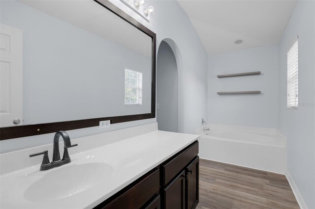 2255 Tealwood Cir, Tavares, FL 32778 - bathroom featuring a bath, wood finished floors, and vanity