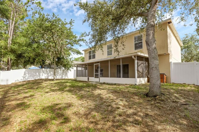 2255 Tealwood Cir, Tavares, FL 32778 - back of property featuring a sunroom and stucco siding