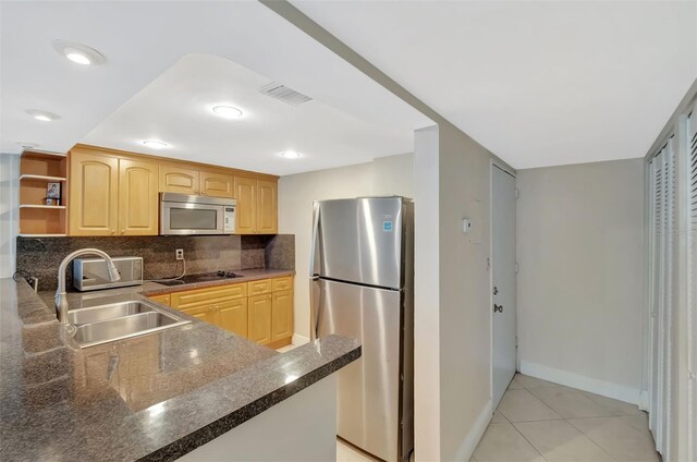 345 Ocean Dr Unit 305, Miami Beach, FL 33139 - kitchen with freestanding refrigerator, a sink, open shelves, black electric cooktop, and light brown cabinetry