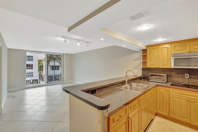 345 Ocean Dr Unit 305, Miami Beach, FL 33139 - kitchen with stainless steel microwave, a sink, cooktop, a peninsula, and open shelves