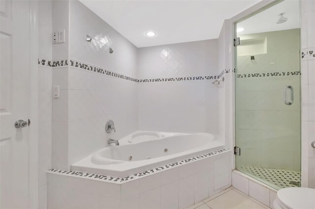 345 Ocean Dr Unit 305, Miami Beach, FL 33139 - full bathroom with a stall shower, a jetted tub, toilet, and tile patterned flooring