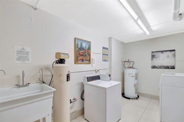 345 Ocean Dr Unit 305, Miami Beach, FL 33139 - community laundry room with water heater, washing machine and dryer, and light tile patterned floors