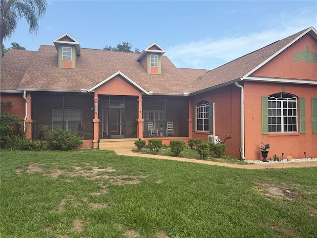 1031 Kings Hwy, Kissimmee, FL 34744 - view of front of home with a sunroom, roof with shingles, and a front yard