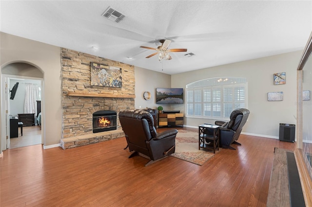 1031 Kings Hwy, Kissimmee, FL 34744 - living area featuring a ceiling fan, wood finished floors, and a stone fireplace