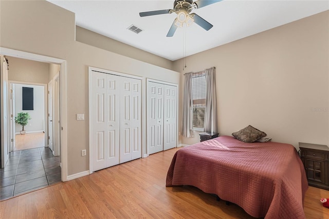 1031 Kings Hwy, Kissimmee, FL 34744 - bedroom with two closets, light wood finished floors, and a ceiling fan