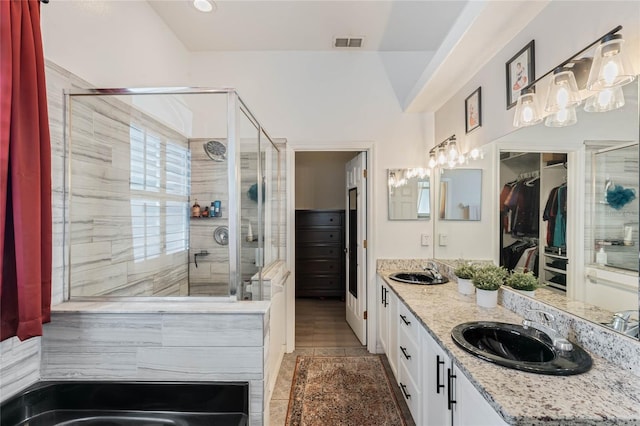 1031 Kings Hwy, Kissimmee, FL 34744 - bathroom with a shower stall, double vanity, and a spacious closet