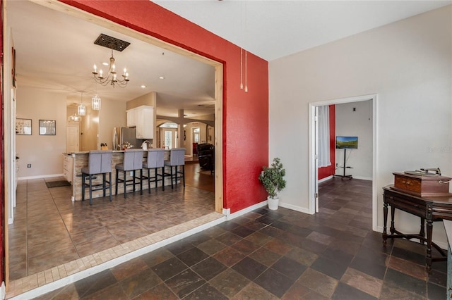 1031 Kings Hwy, Kissimmee, FL 34744 - interior space featuring a chandelier and dark stone finish flooring