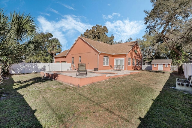 1031 Kings Hwy, Kissimmee, FL 34744 - rear view of house with a fenced backyard, a patio area, stucco siding, and a shed