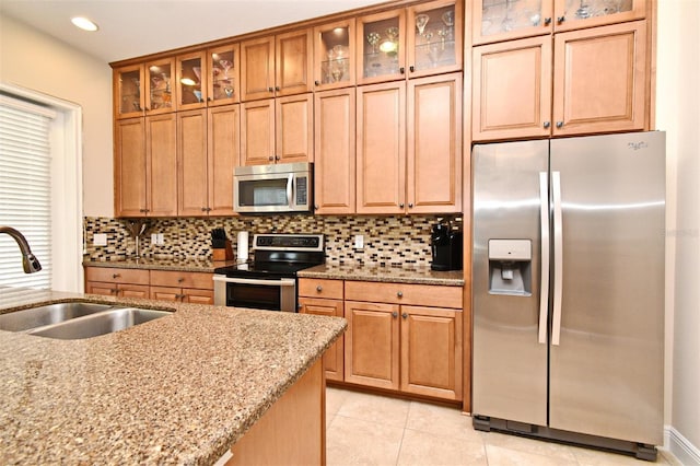 312 Trieste Loop, Lake Mary, FL 32746 - kitchen featuring stainless steel appliances, a sink, decorative backsplash, light stone countertops, and recessed lighting