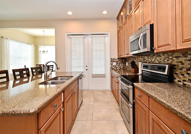 312 Trieste Loop, Lake Mary, FL 32746 - kitchen with stainless steel appliances, a sink, decorative backsplash, light tile patterned floors, and recessed lighting