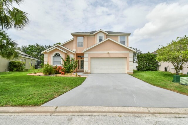 831 Corvina Dr, Davenport, FL 33897 - traditional-style home featuring stucco siding, a front lawn, concrete driveway, and an attached garage