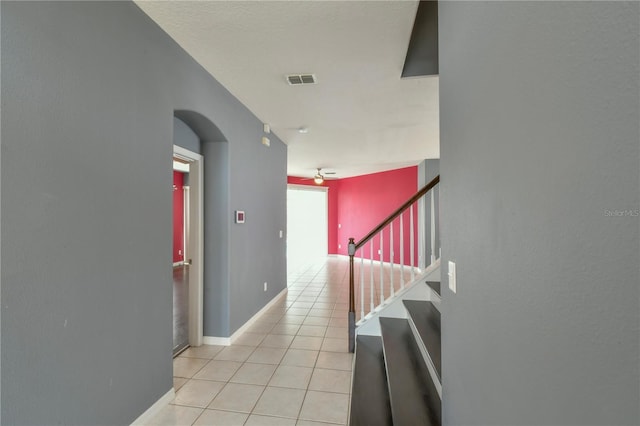 831 Corvina Dr, Davenport, FL 33897 - hallway with light tile patterned floors, arched walkways, and stairway
