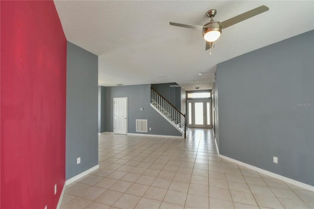 831 Corvina Dr, Davenport, FL 33897 - empty room featuring stairway, ceiling fan, and light tile patterned flooring