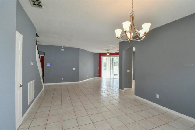 831 Corvina Dr, Davenport, FL 33897 - empty room with a chandelier and light tile patterned flooring