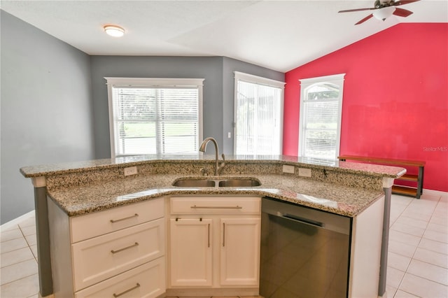 831 Corvina Dr, Davenport, FL 33897 - kitchen featuring stainless steel dishwasher, a ceiling fan, lofted ceiling, light stone countertops, and light tile patterned floors