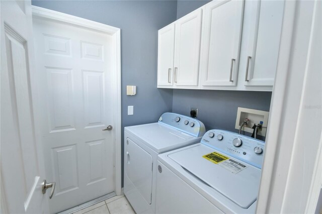831 Corvina Dr, Davenport, FL 33897 - washroom with cabinet space, washing machine and clothes dryer, and light tile patterned floors