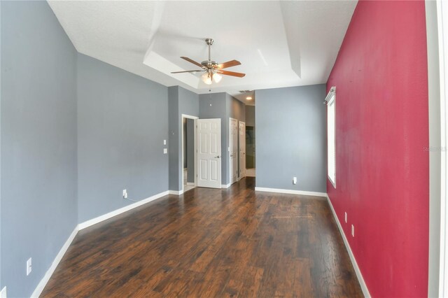 831 Corvina Dr, Davenport, FL 33897 - unfurnished bedroom featuring a raised ceiling, wood finished floors, and ceiling fan