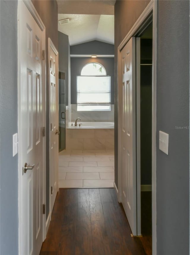 831 Corvina Dr, Davenport, FL 33897 - corridor with vaulted ceiling and hardwood / wood-style flooring