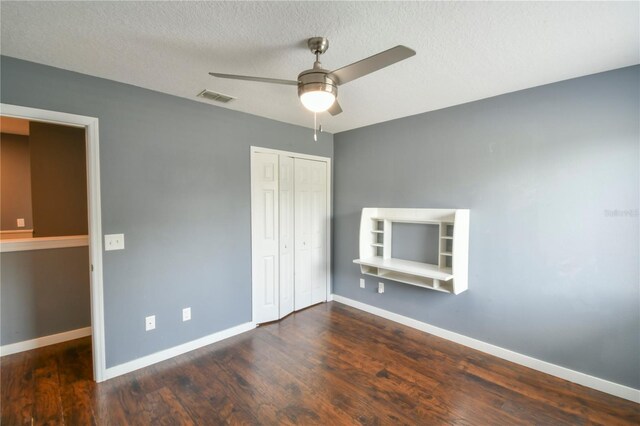 831 Corvina Dr, Davenport, FL 33897 - unfurnished bedroom with a closet, wood finished floors, a textured ceiling, and a ceiling fan
